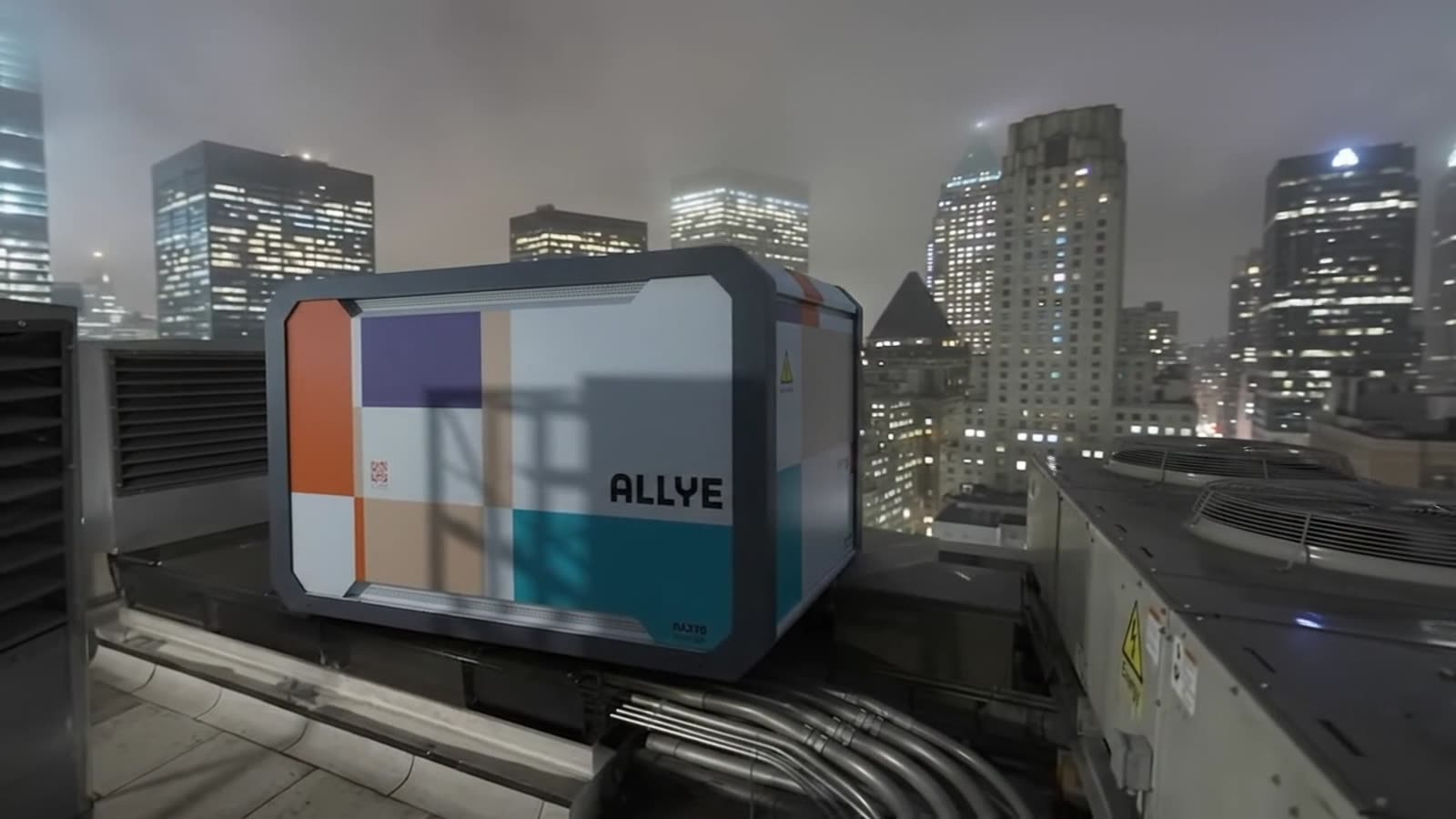 Allye MAX battery unit on a city rooftop at dusk, replacing a standby generator